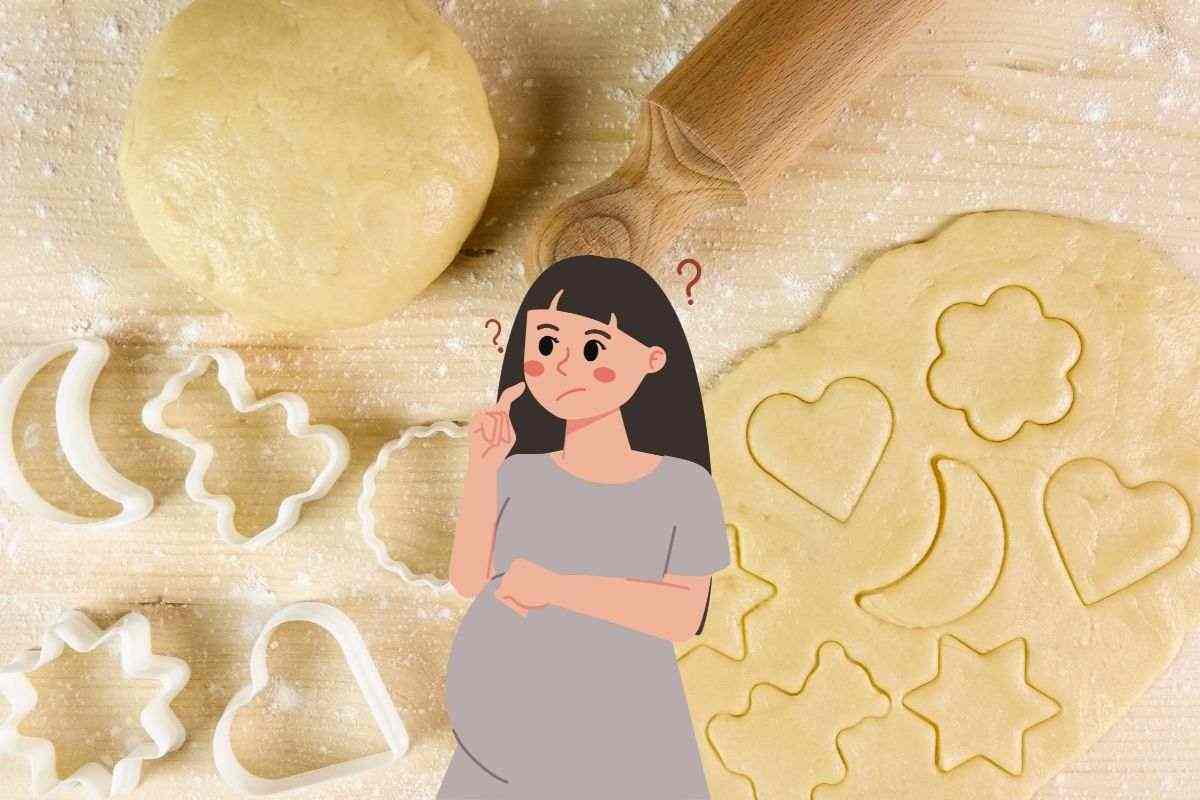 pasta frolla e biscotti sullo sfondo, in primo piano disegno di una donna incinta che si pone interrogativi